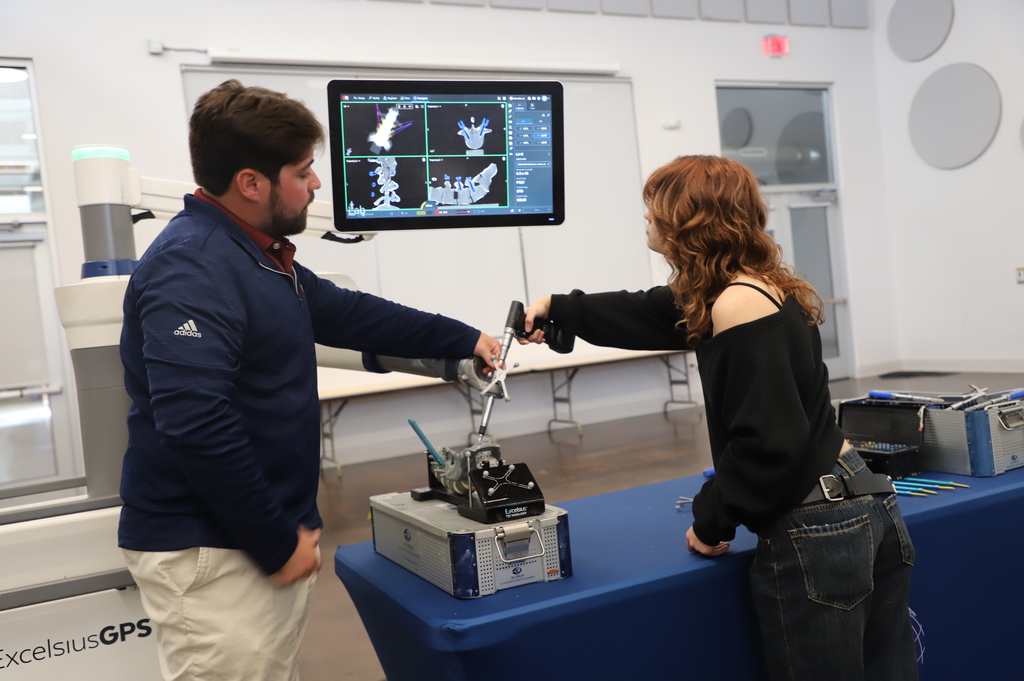 student uses a surgical robot