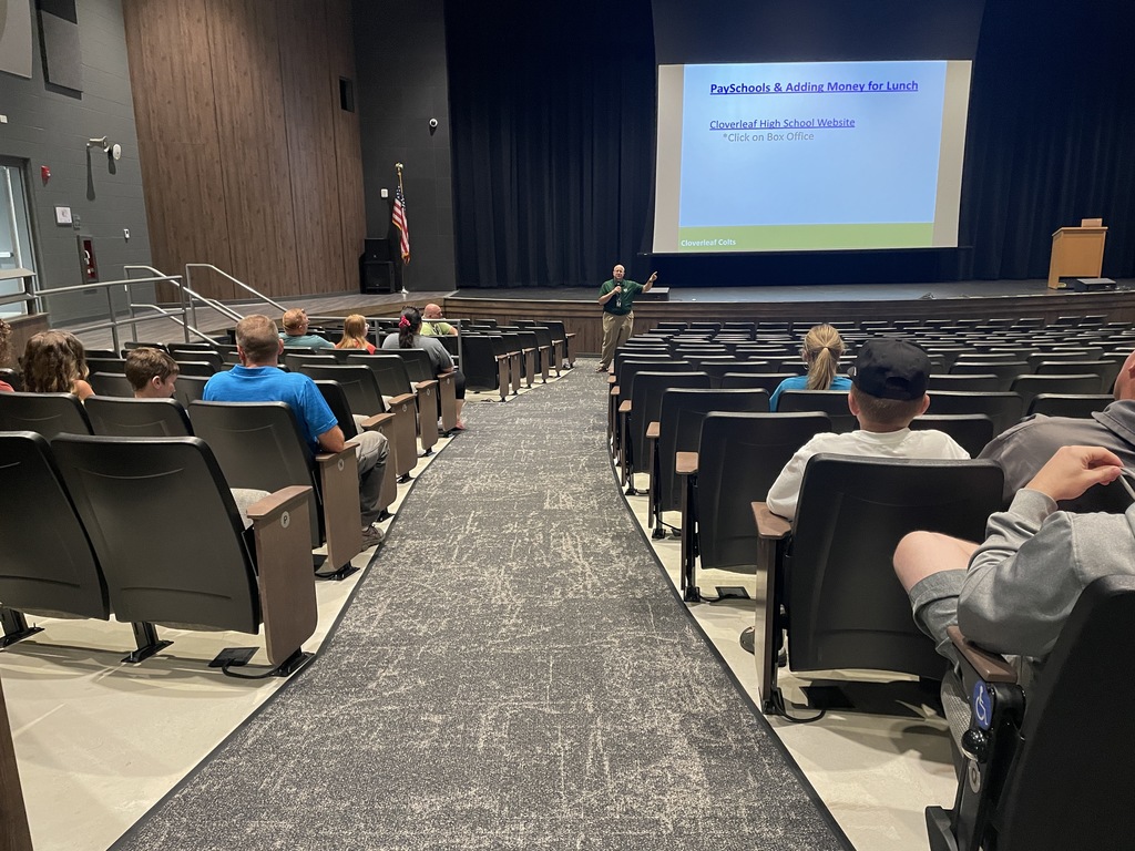 Mr. Miller in the auditorium speaking to families
