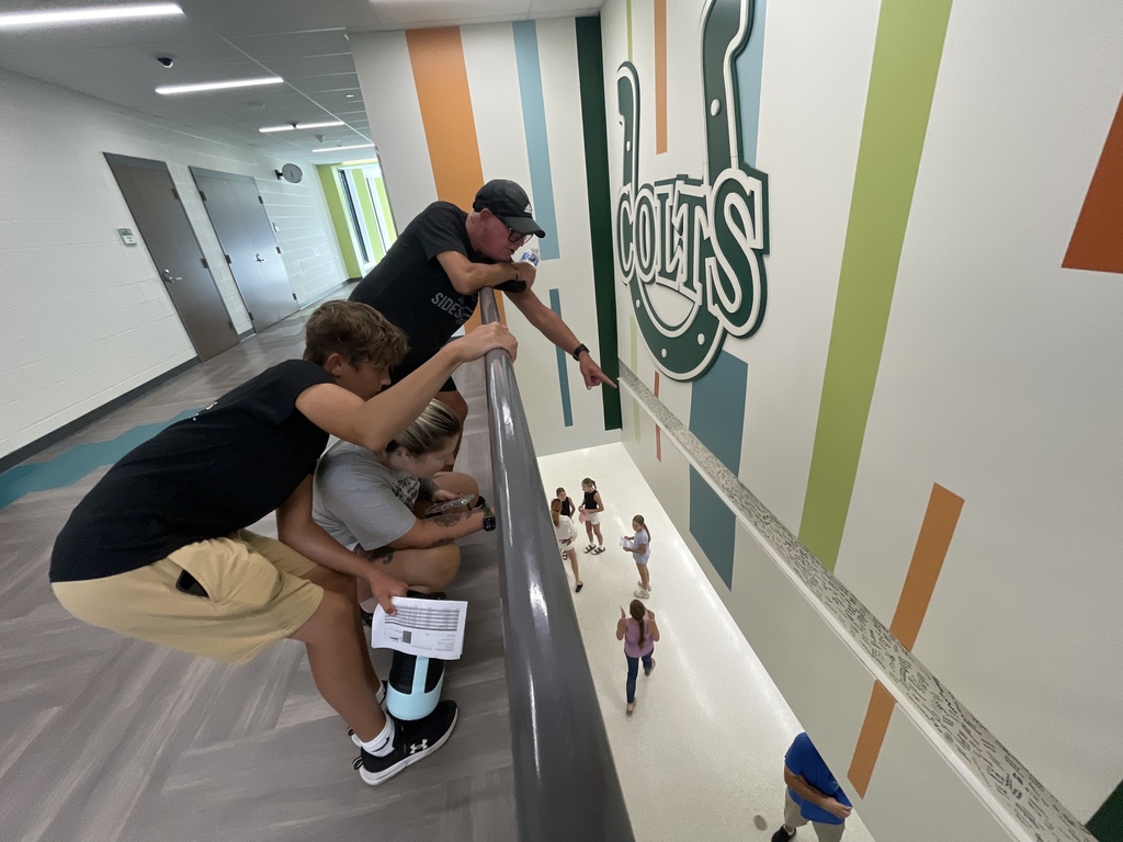 Family pointing at signed beam
