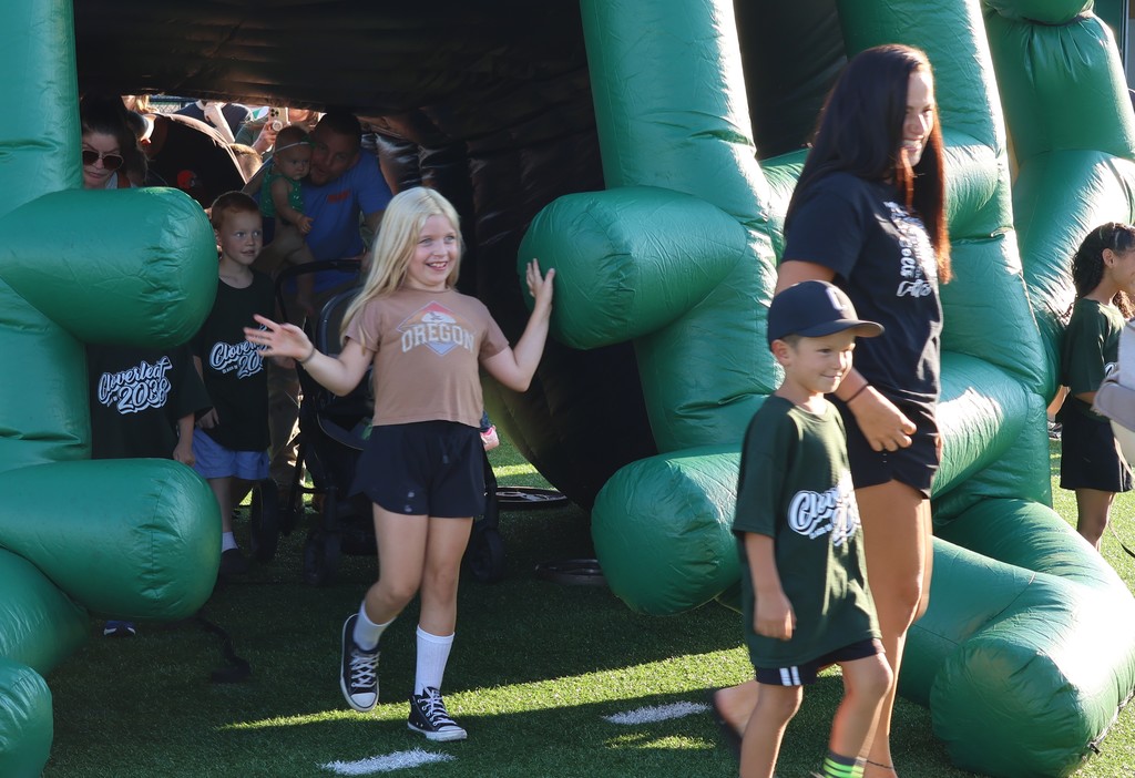 Girl emerging from inflatable helmet
