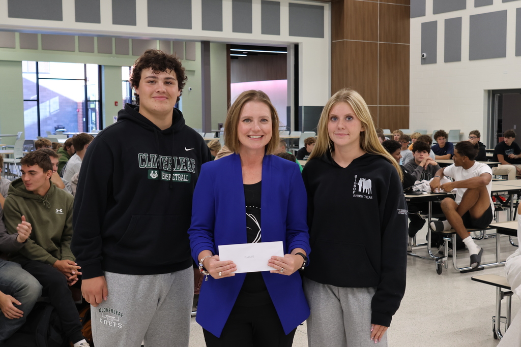 Students with check presentation