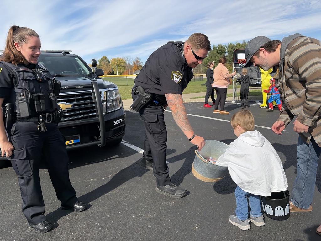 Child getting candy from  police officer