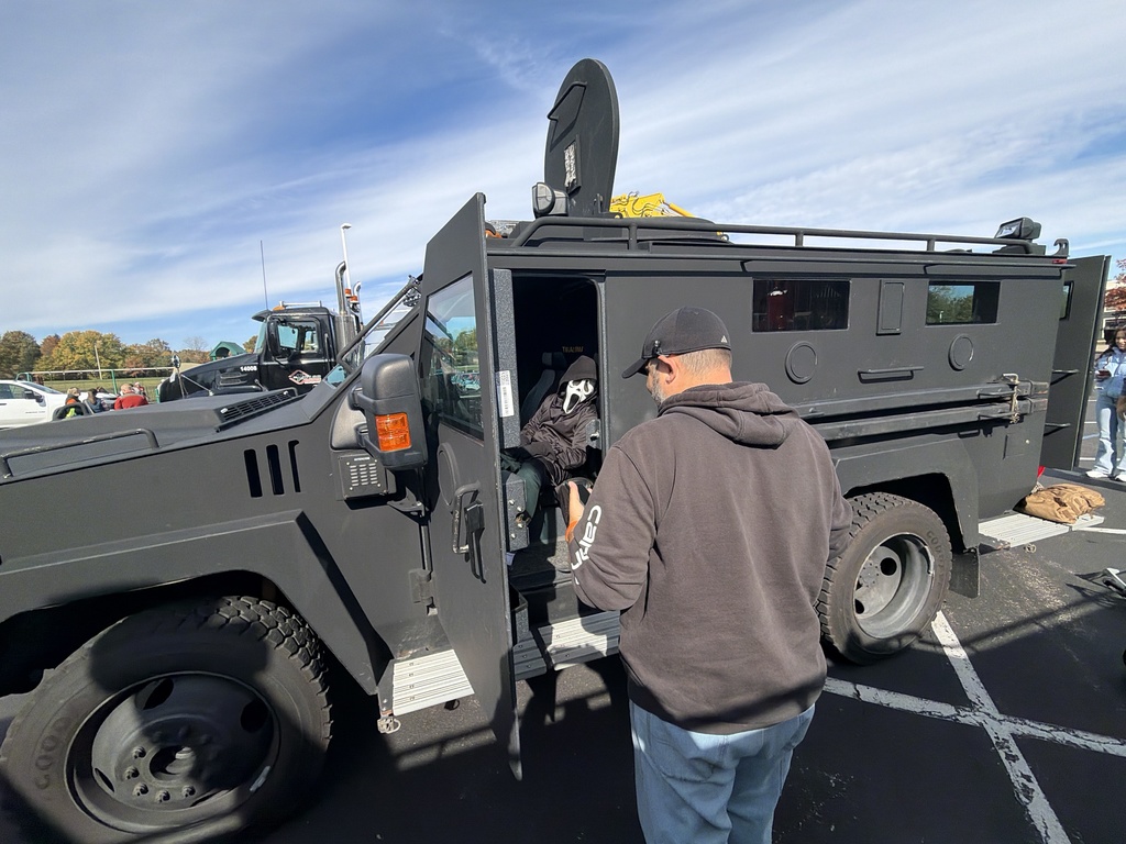 Boy in costume in a military truck