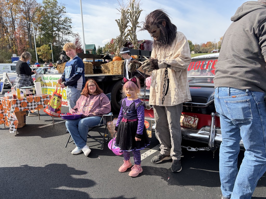 Girl in costume taking picture with man in werewolf costume