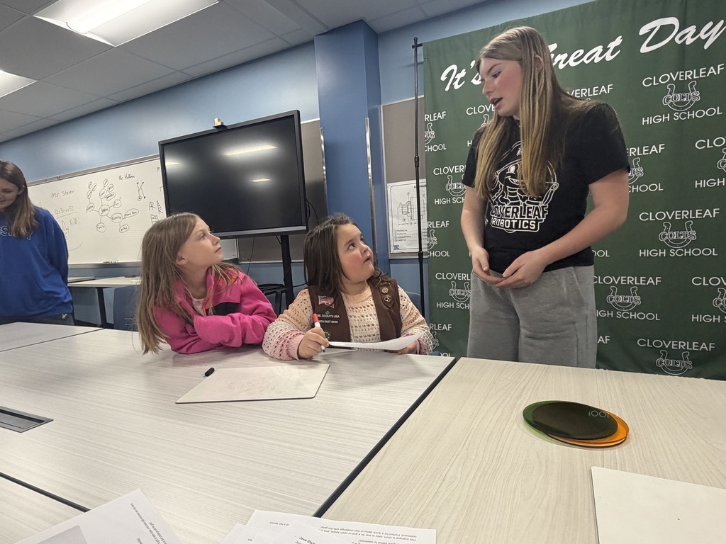 Robotics Team member explaining coding to Girl Scouts
