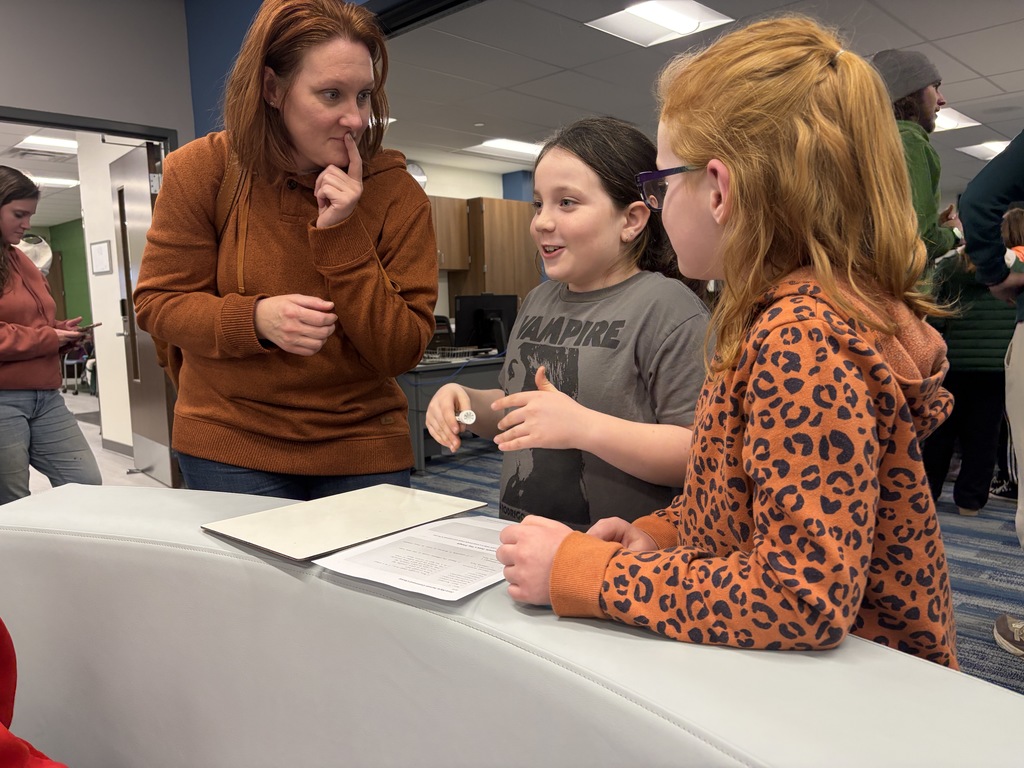 Parent and Girl Scouts working on coding