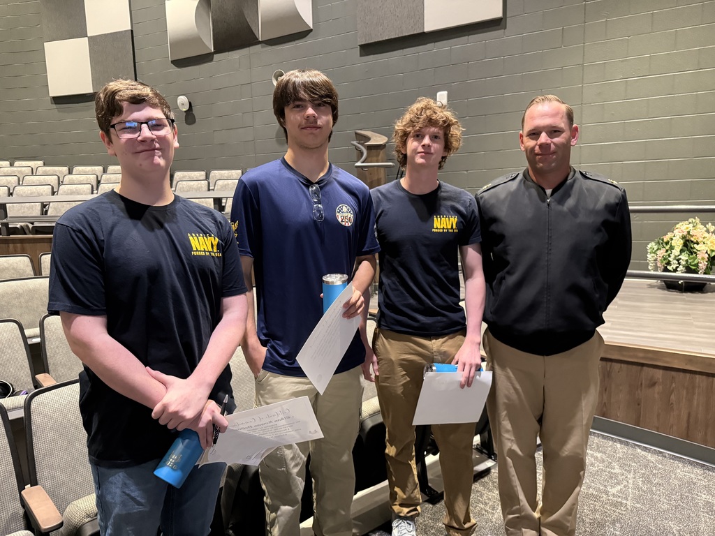 Students and wearing military T-shirts standing with recruiter