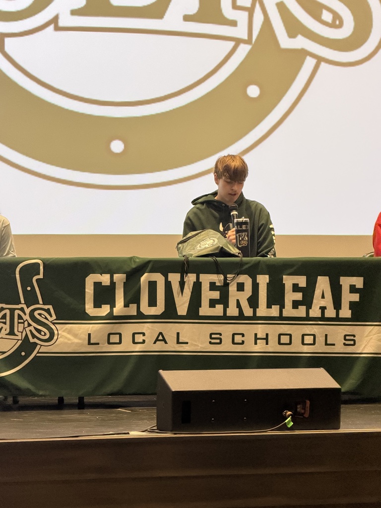 Student at table speaking into microphone