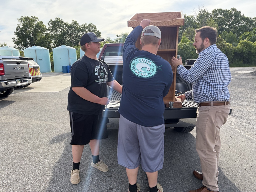 Greg and students unloading podium from truck