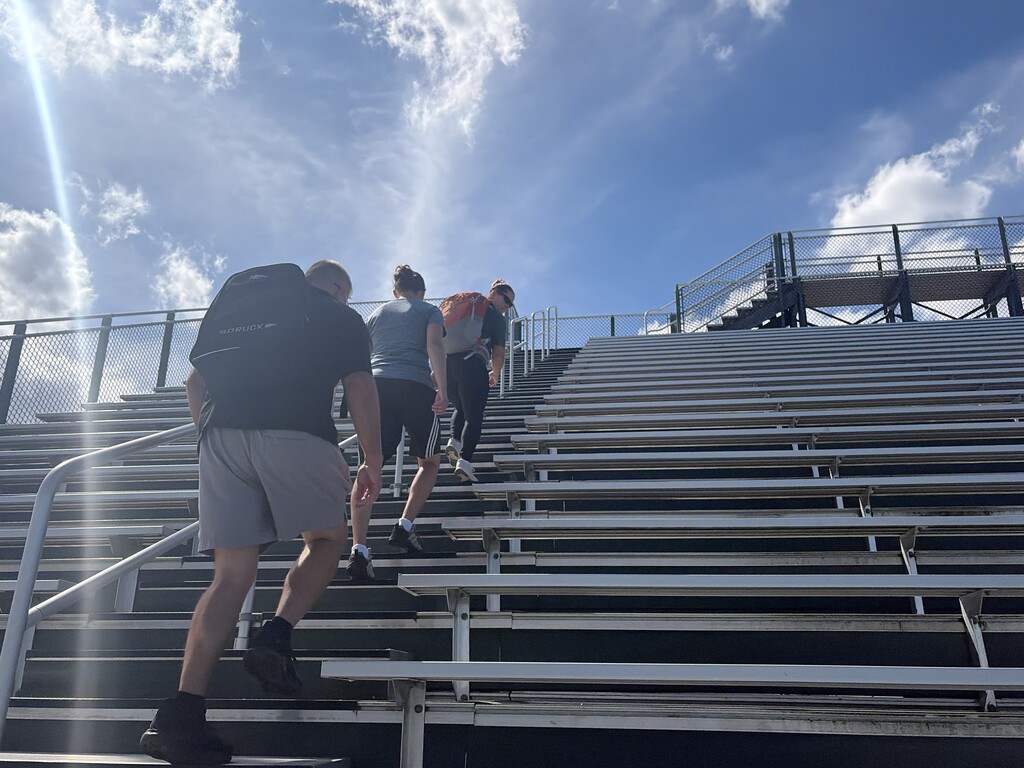 Teachers climbing stadium steps