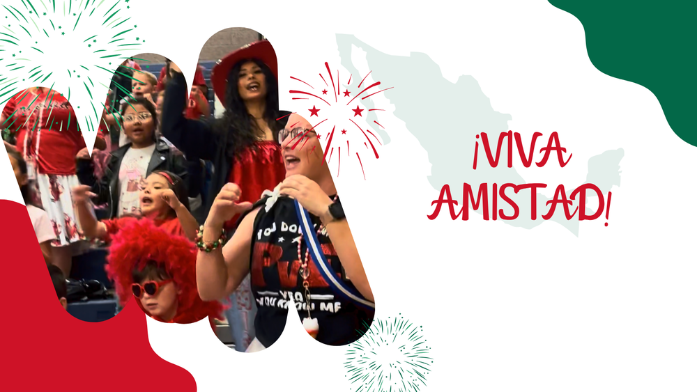 Adults and children wearing red accessories. They are smiling. There is a red, green, and white background with Viva Amistad.
