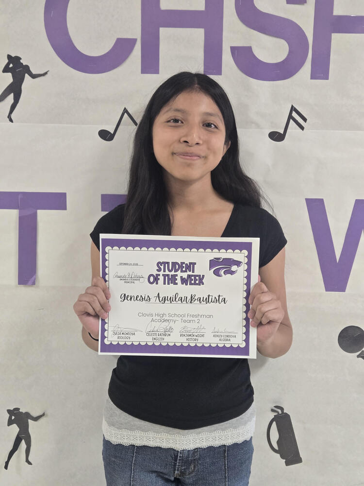 Student of the week holding certificate