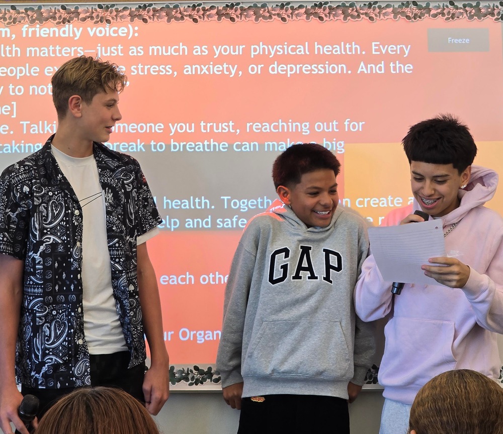 Students presenting radio announcement in health class