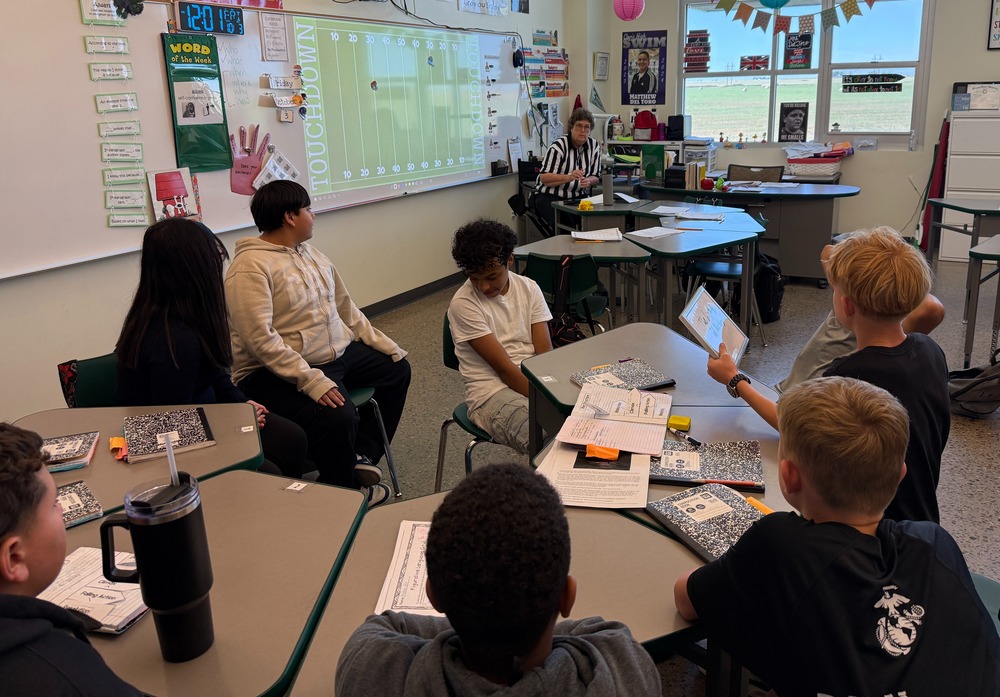 8th grade students Gwyn Del Toro's English class play a football review game.
