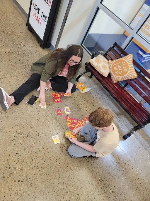 Teacher and student playing cards