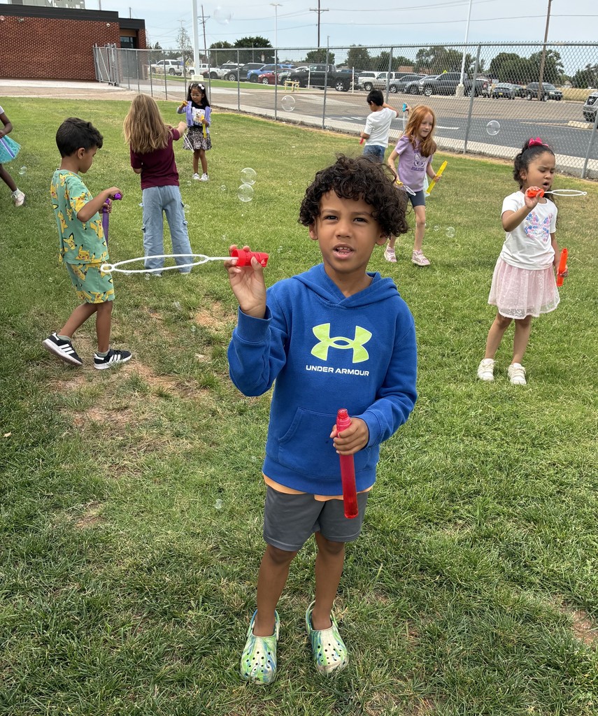 A group of kids blowing bubbles for a self control lesson