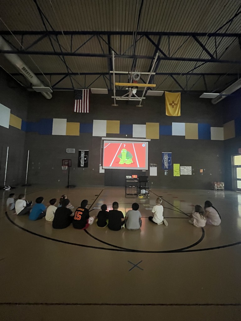 Students watching a video. There is a turtle on a running track,