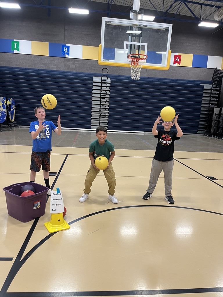 Students using a medicine ball to excercise.