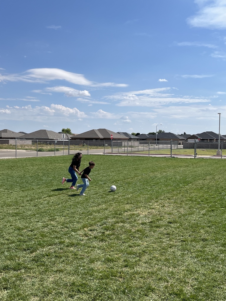 Aliyus and Mrs. Rojas playing soccer.