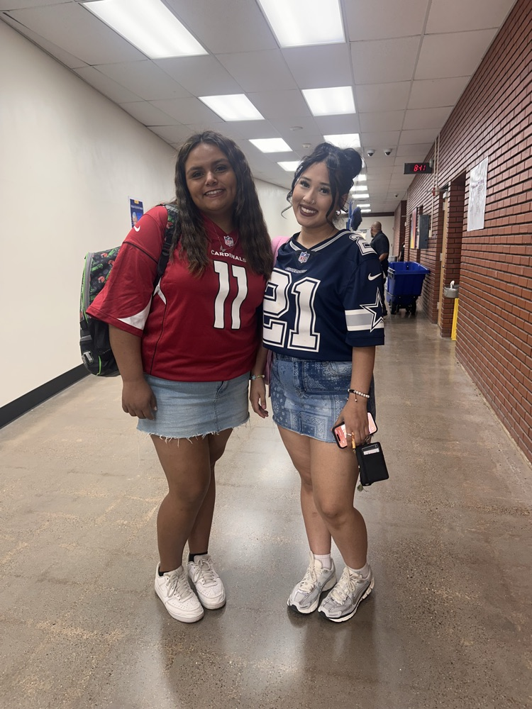 Two students wearing football jerseys