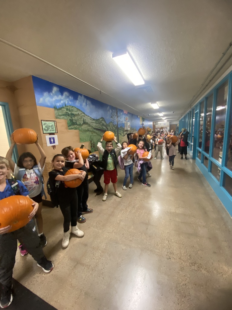 Students holding pumpkins