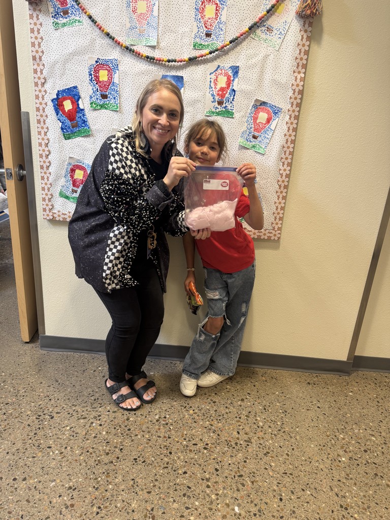Teacher and student holding bag of fluffy slime