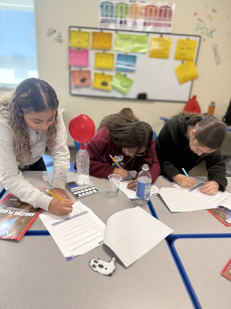 Students writing responses  on papers