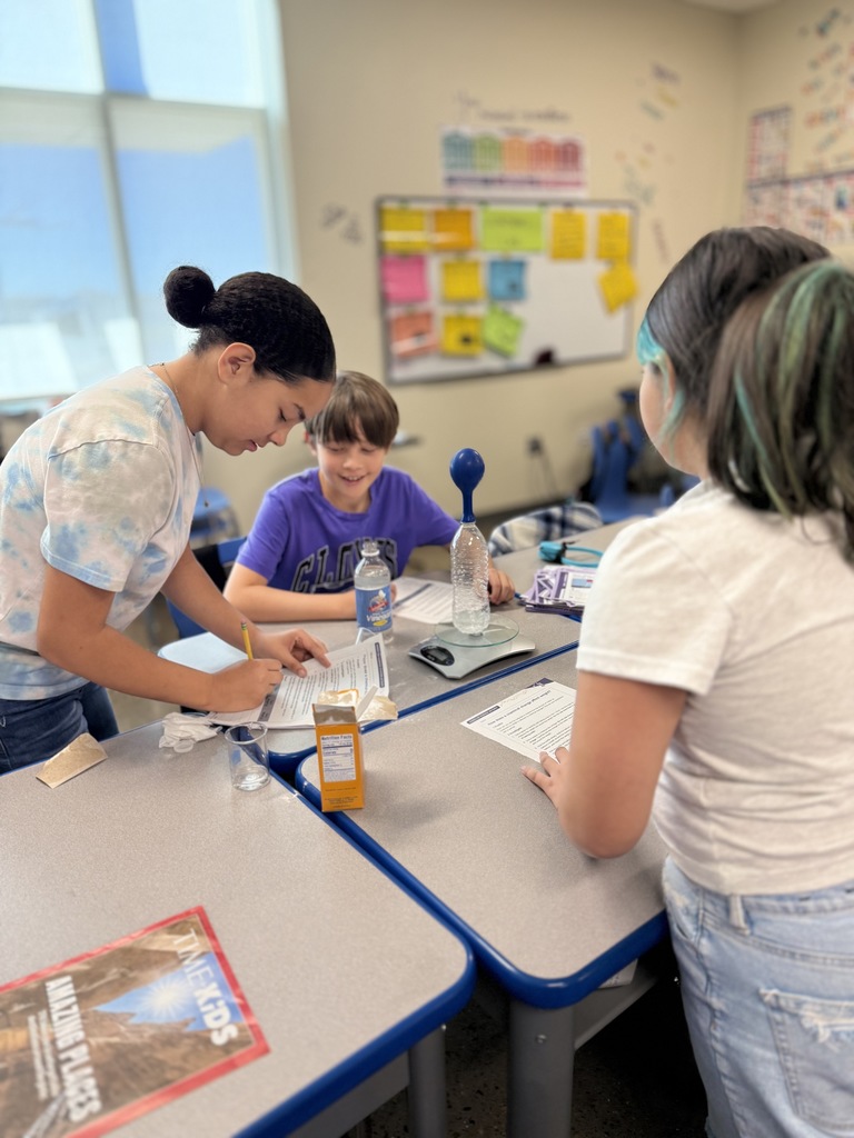 Students taking notes while working on assignment