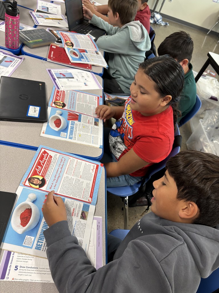 male and female student working together to read along with project directions