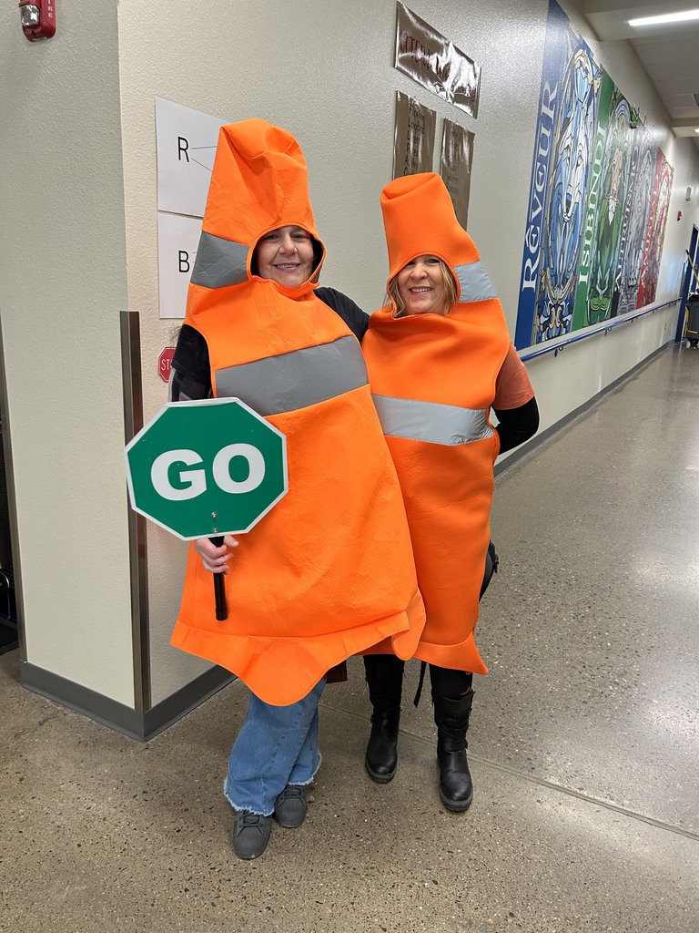 2 ladies dressed as cones for cross walk duty