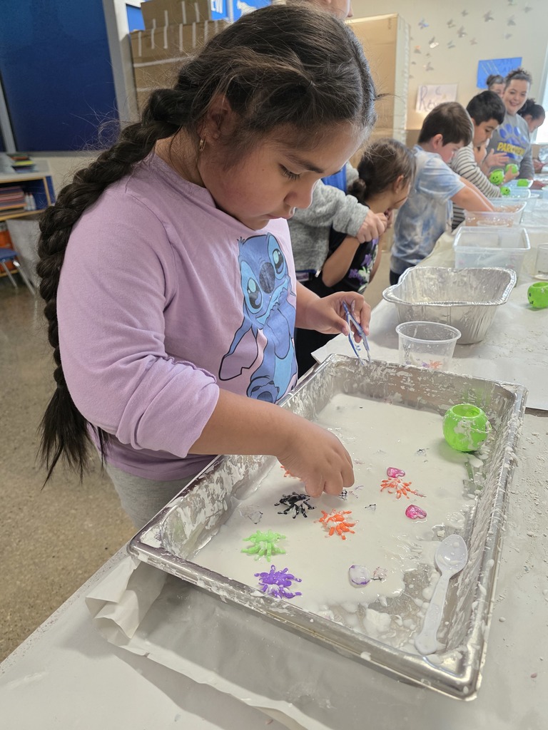 Girl student with her hands inside slime.