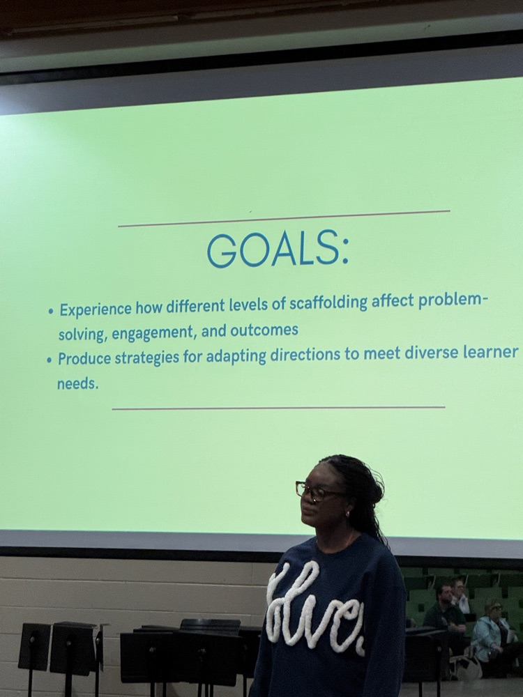 Teacher in front of a slide show