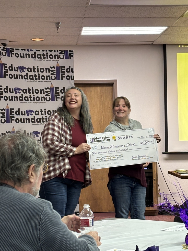 Coach Kasi with Mrs. Scism and the Grant check that was awarded for STEM Sports