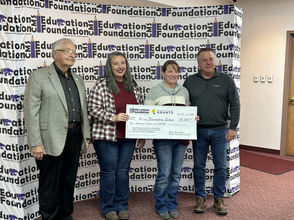 Coach Kasi and Mrs. Scism with two CMS Education Foundation Board Members holding a Grant check that was awarded for STEM Sports 