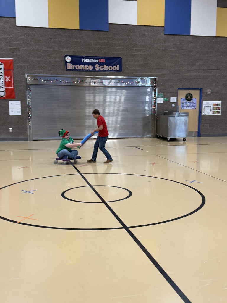 student pulling another student riding a scooter