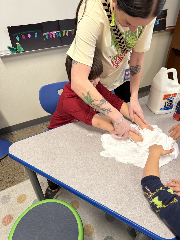 Mrs. Clark assisting a student with the slime.