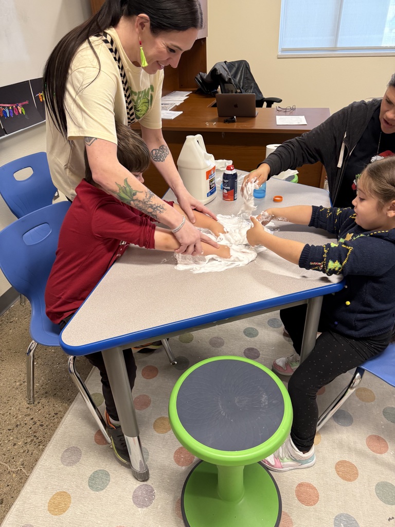 Students making slime with Mrs. Clark
