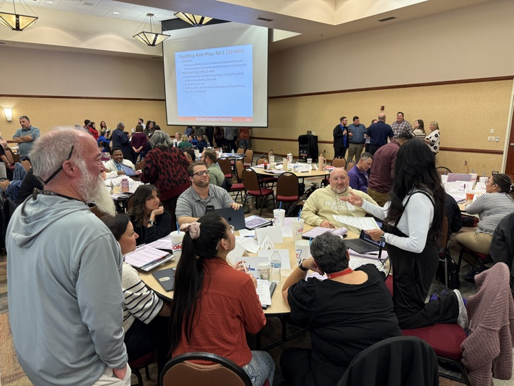 Teachers attending a workshop seated around a table