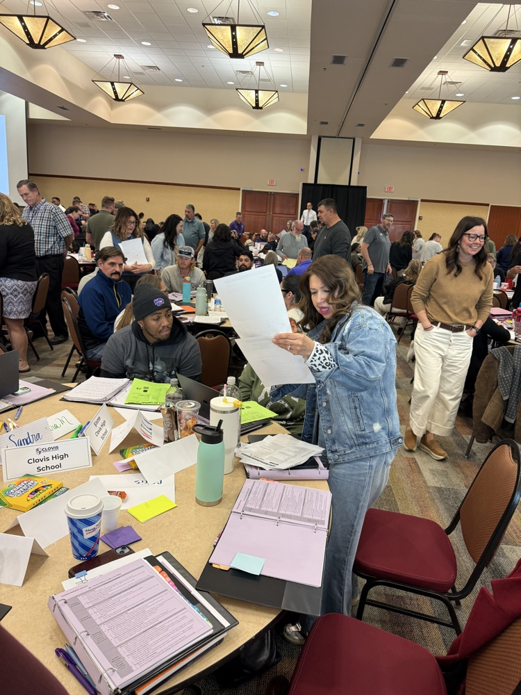 Teachers looking over handouts