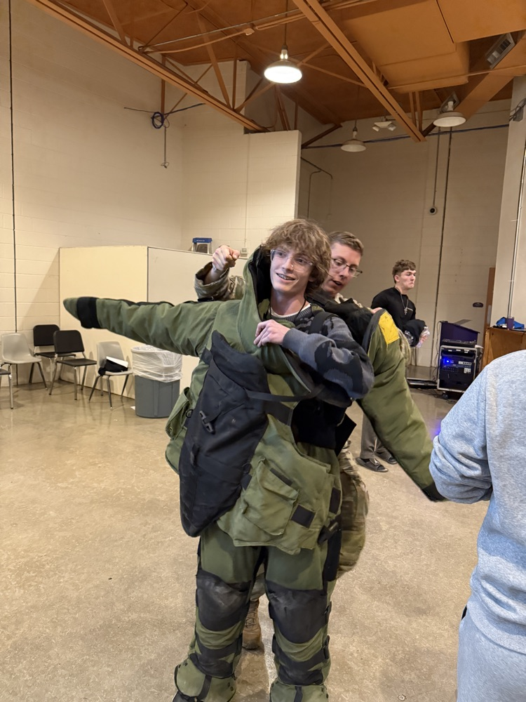 Student tries on protective outfit