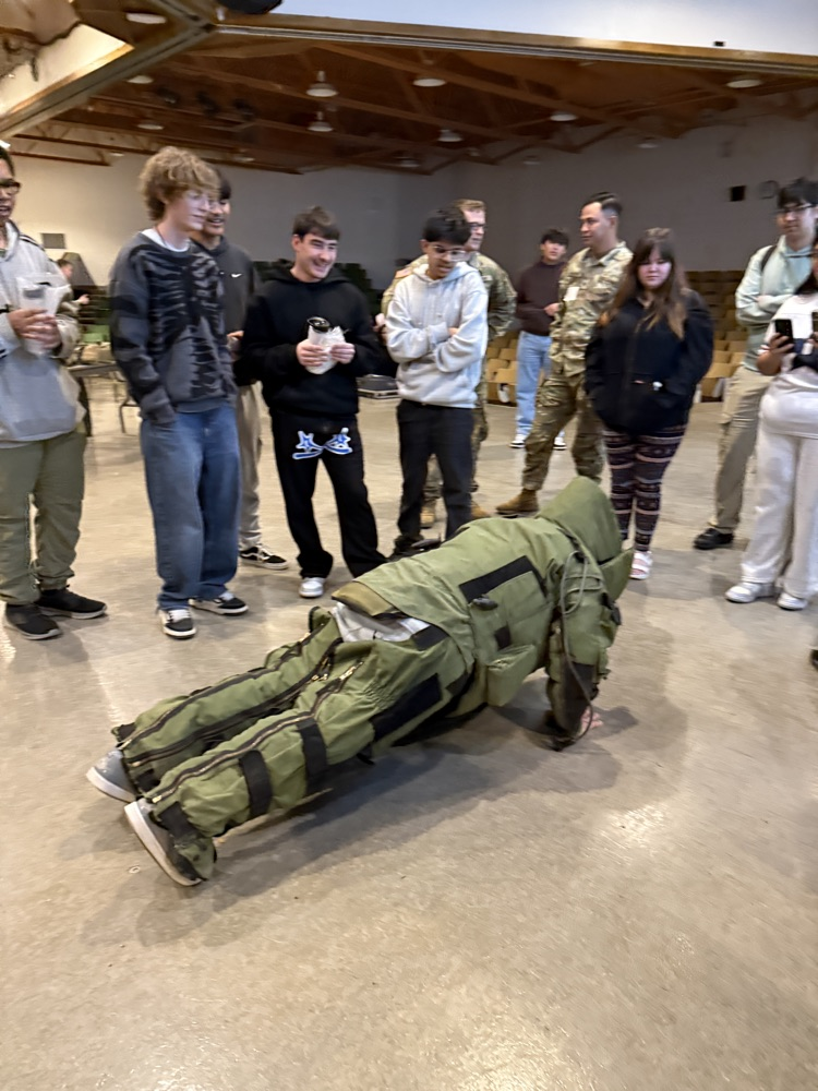 Student doing a push up in protective garment. 