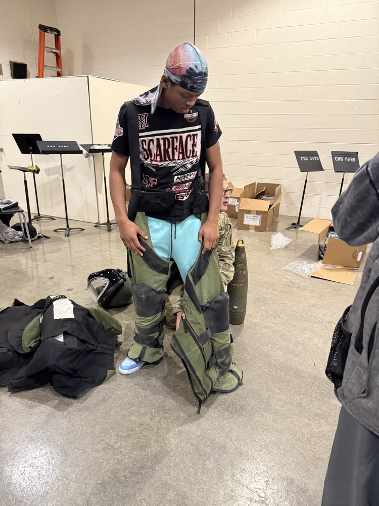 Student putting on protective pants