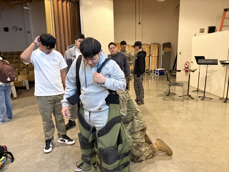 Students trying on gear