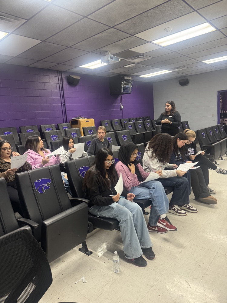Students looking at a paper.