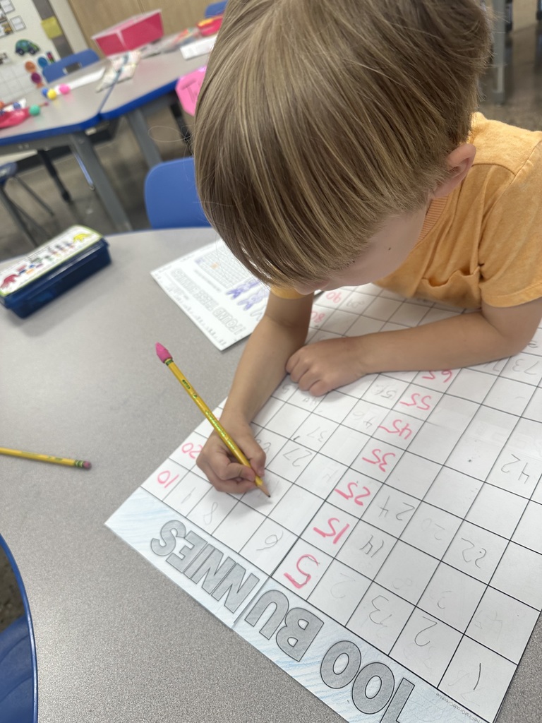 Mrs. Sullivan and Ms. Tapia's class Hunting numbered eggs for a 100's chart