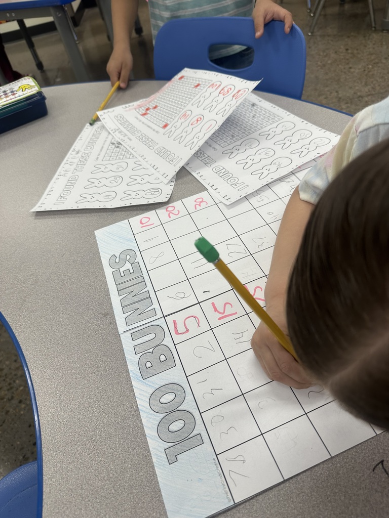 Mrs. Sullivan and Ms. Tapia's class Hunting numbered eggs for a 100's chart