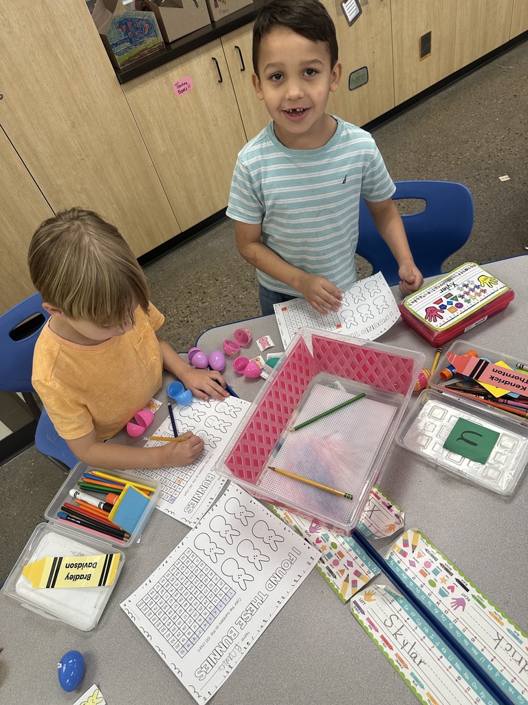 Mrs. Sullivan and Ms. Tapia's class Hunting numbered eggs for a 100's chart