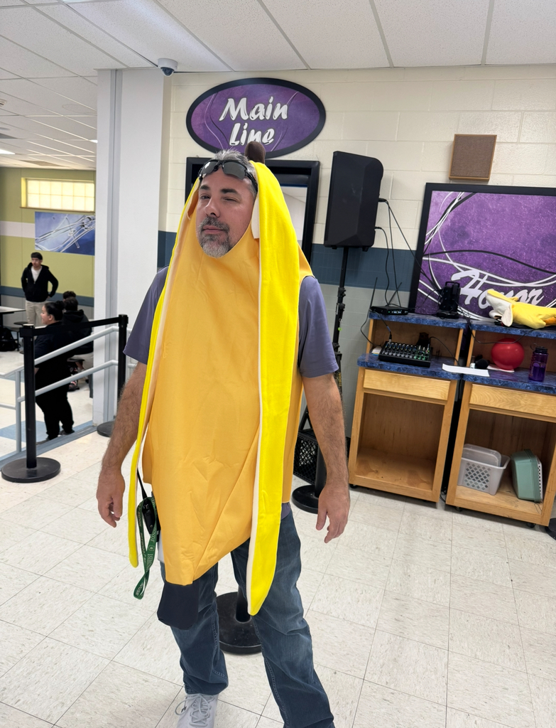 A man in a yellow banana costume with goggles on his head.