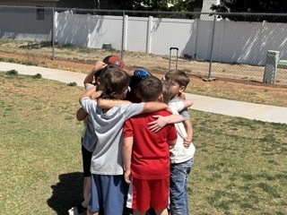 Boys collaborating at field day.