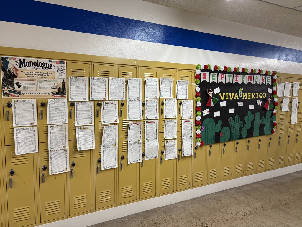 Yellow lockers attached to walls with papers on them. Bulletin board displays "VIVA MEXICO" and cactus decorations.
